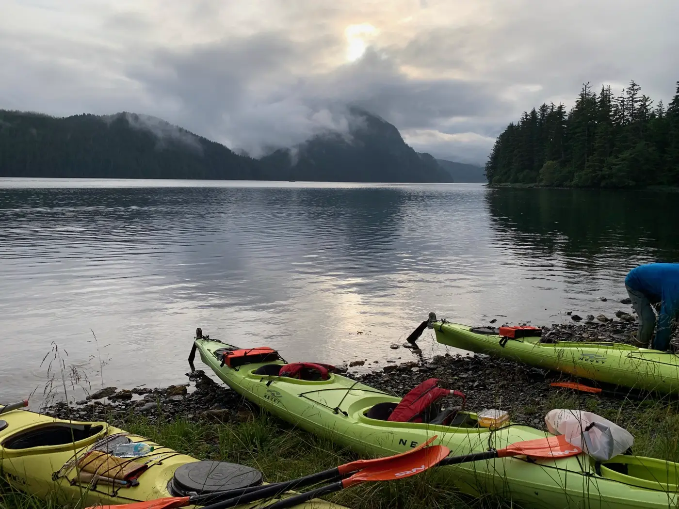 Kayaks and gear staged on the beach, future rental option